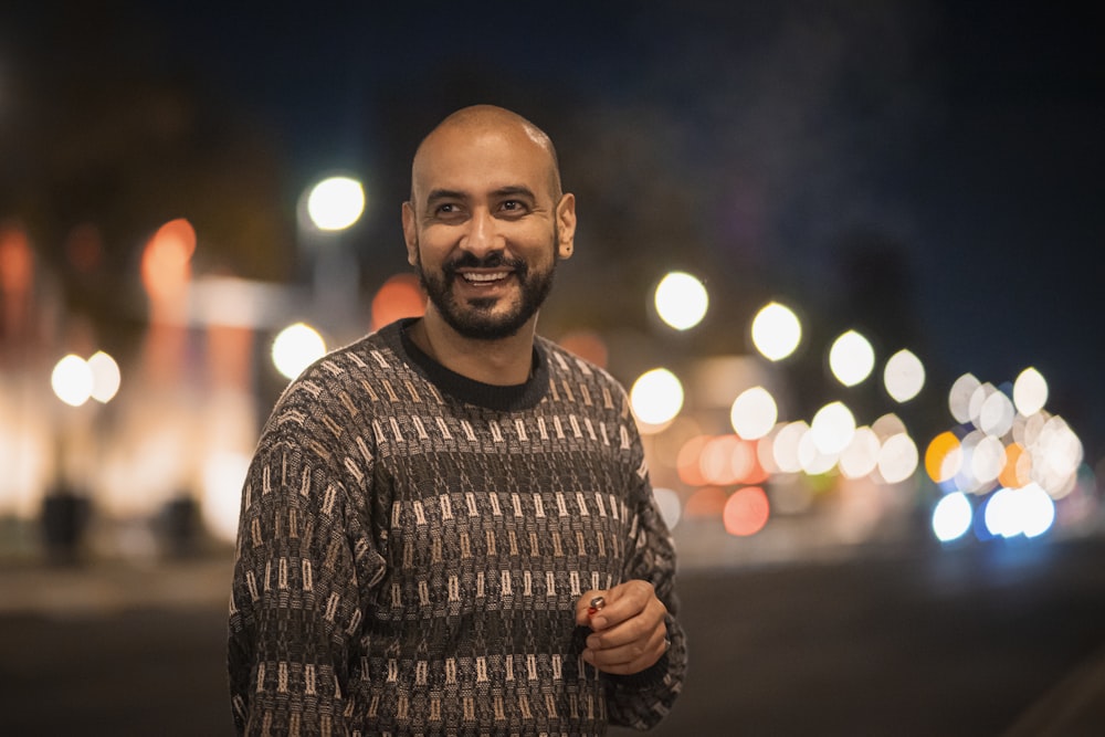 a man standing in the middle of a street at night