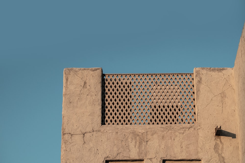 a bird is perched on the side of a building