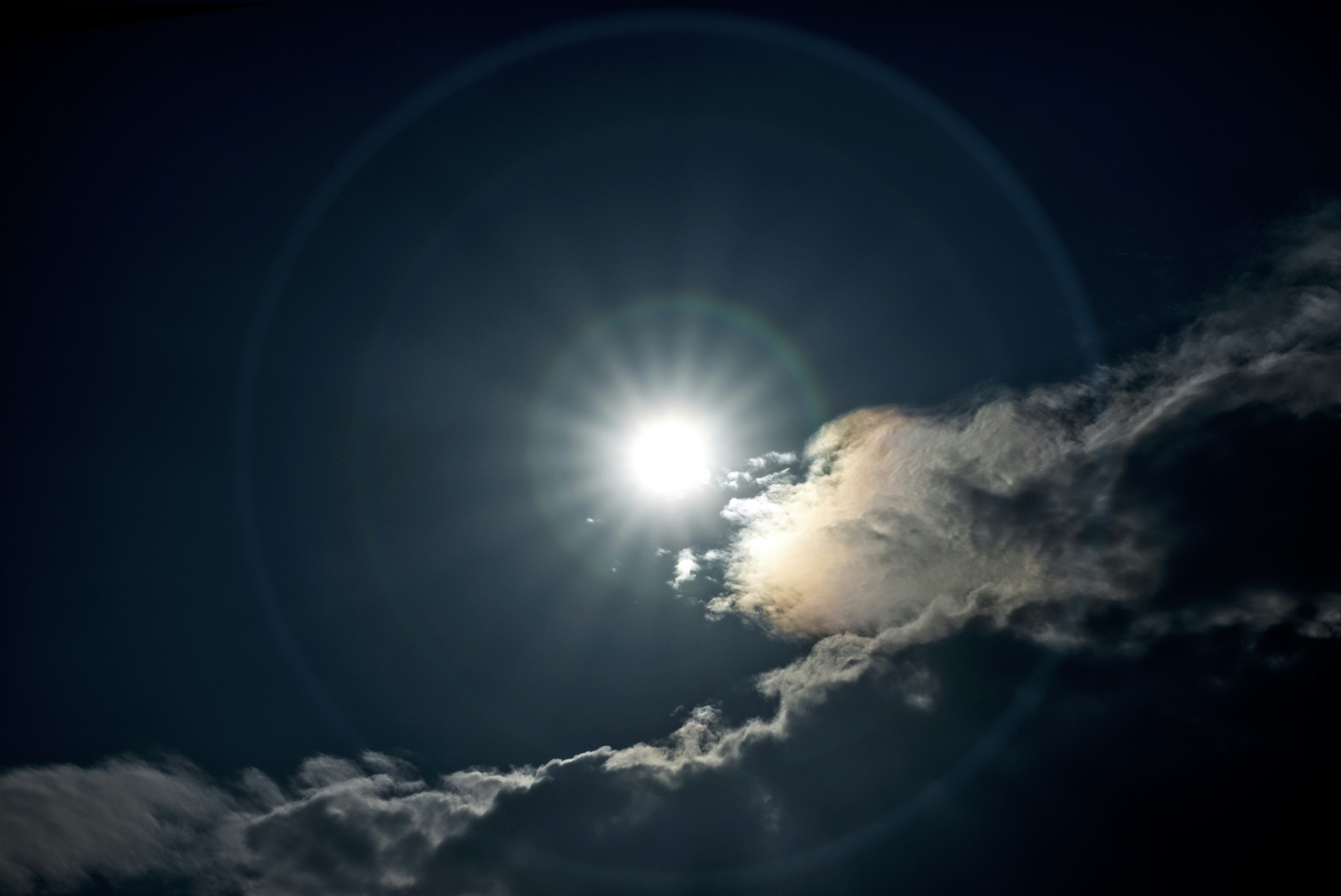 the sun is shining through the clouds in the sky