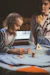 A mother and her two children engaged in a creative activity together.