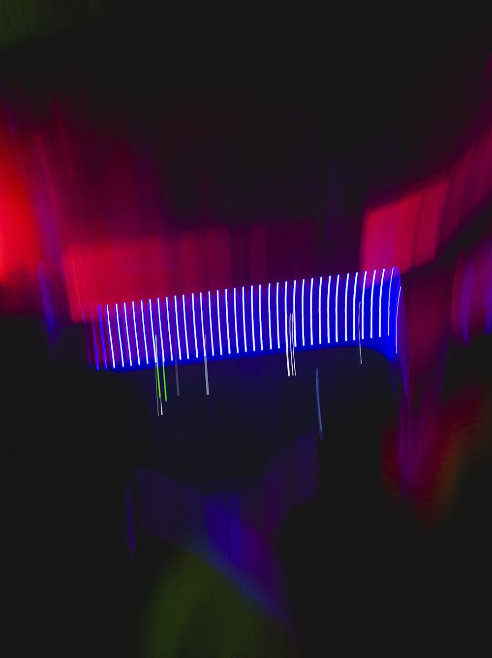 a blurry photo of a bridge in the dark