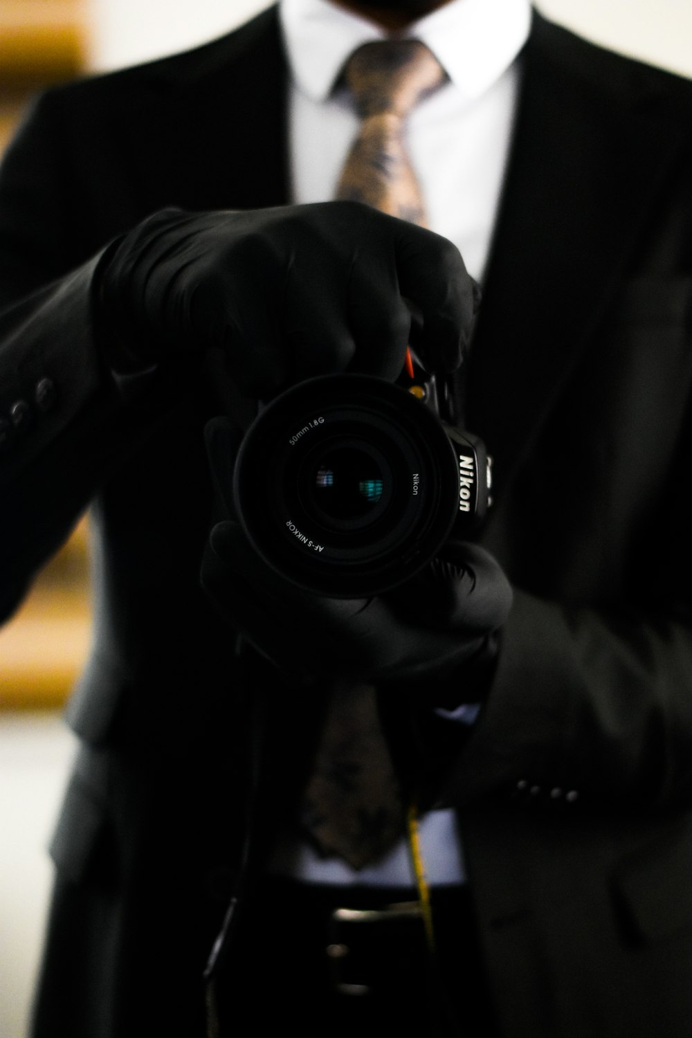 a man in a suit and tie holding a camera