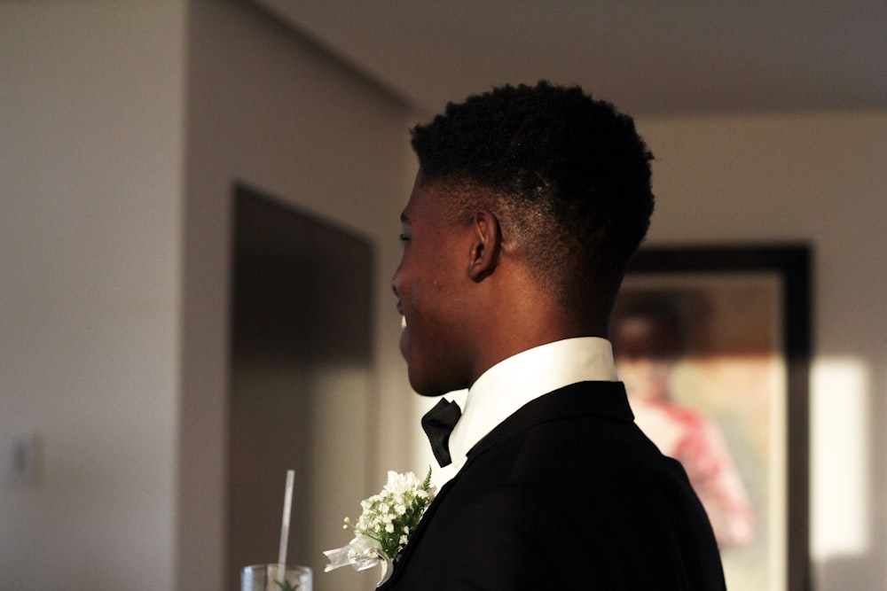 a man in a tuxedo standing in a room