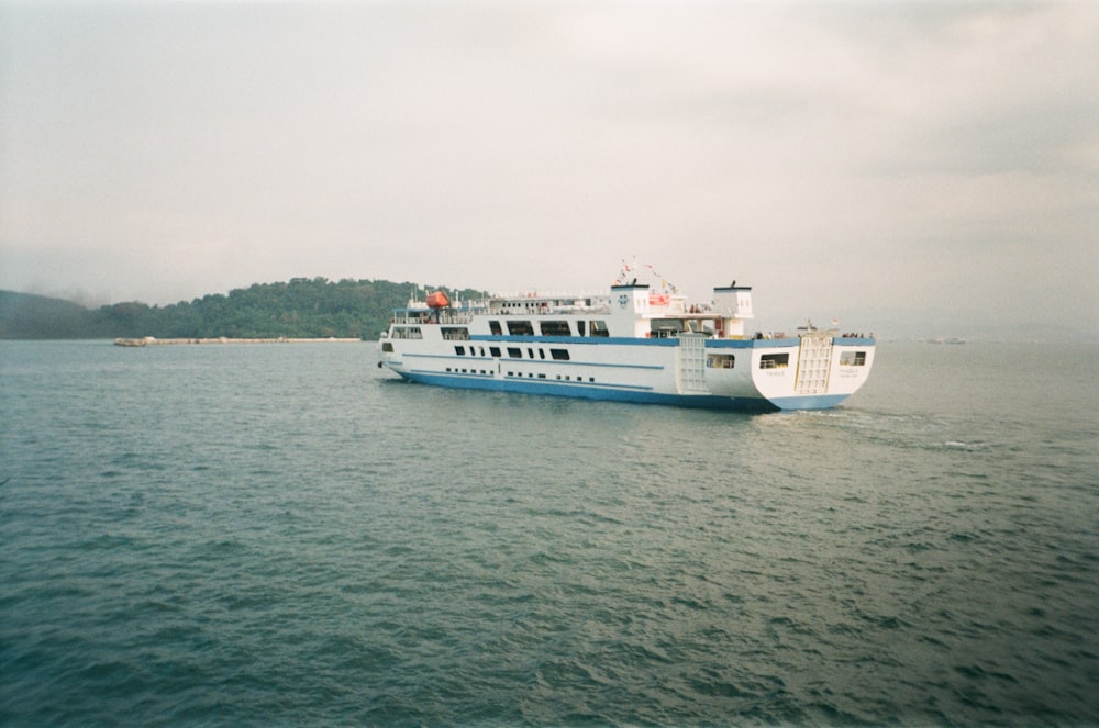 a large white and blue boat in a body of water