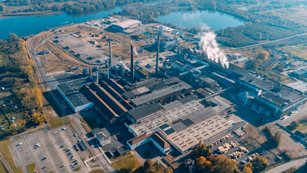 an aerial view of a factory with a river in the background