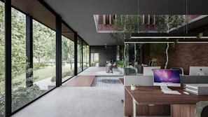 Interior view of a bright, open-plan office space with minimalist furniture and abundant natural light.