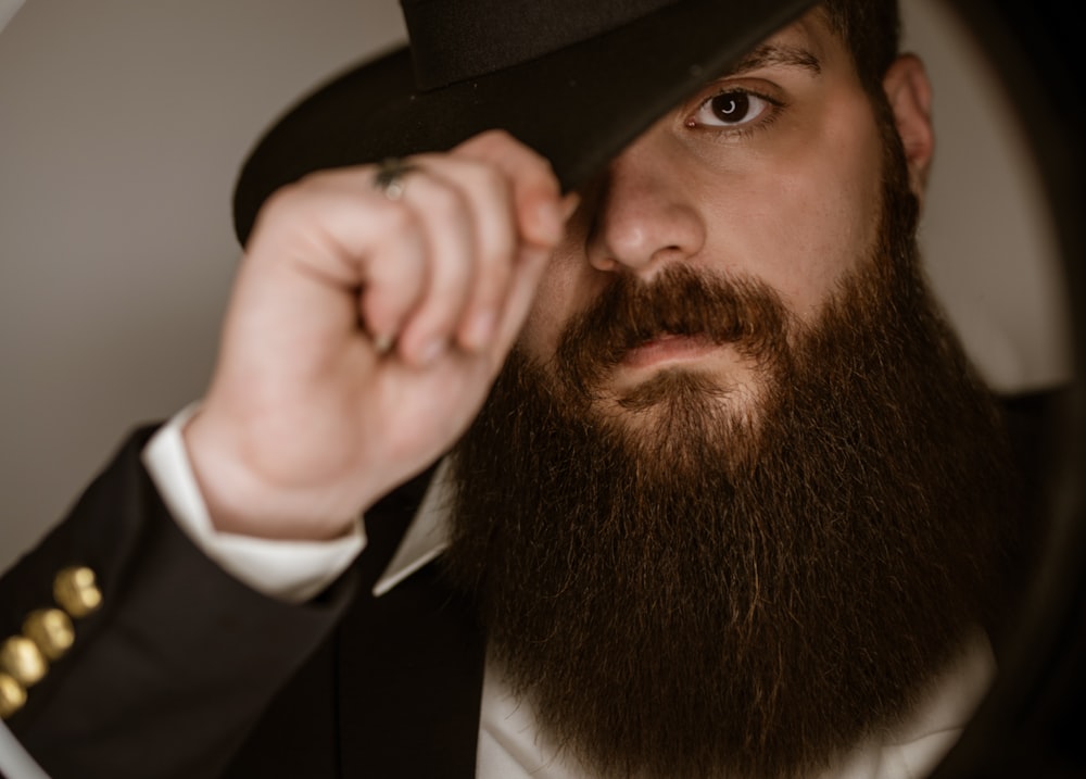 a man with a long beard wearing a hat