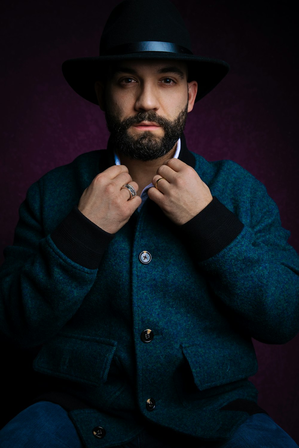 a man with a beard wearing a coat and a hat