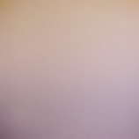 Gradient ombre nails shifting from lavender to powder blue with a matte finish.