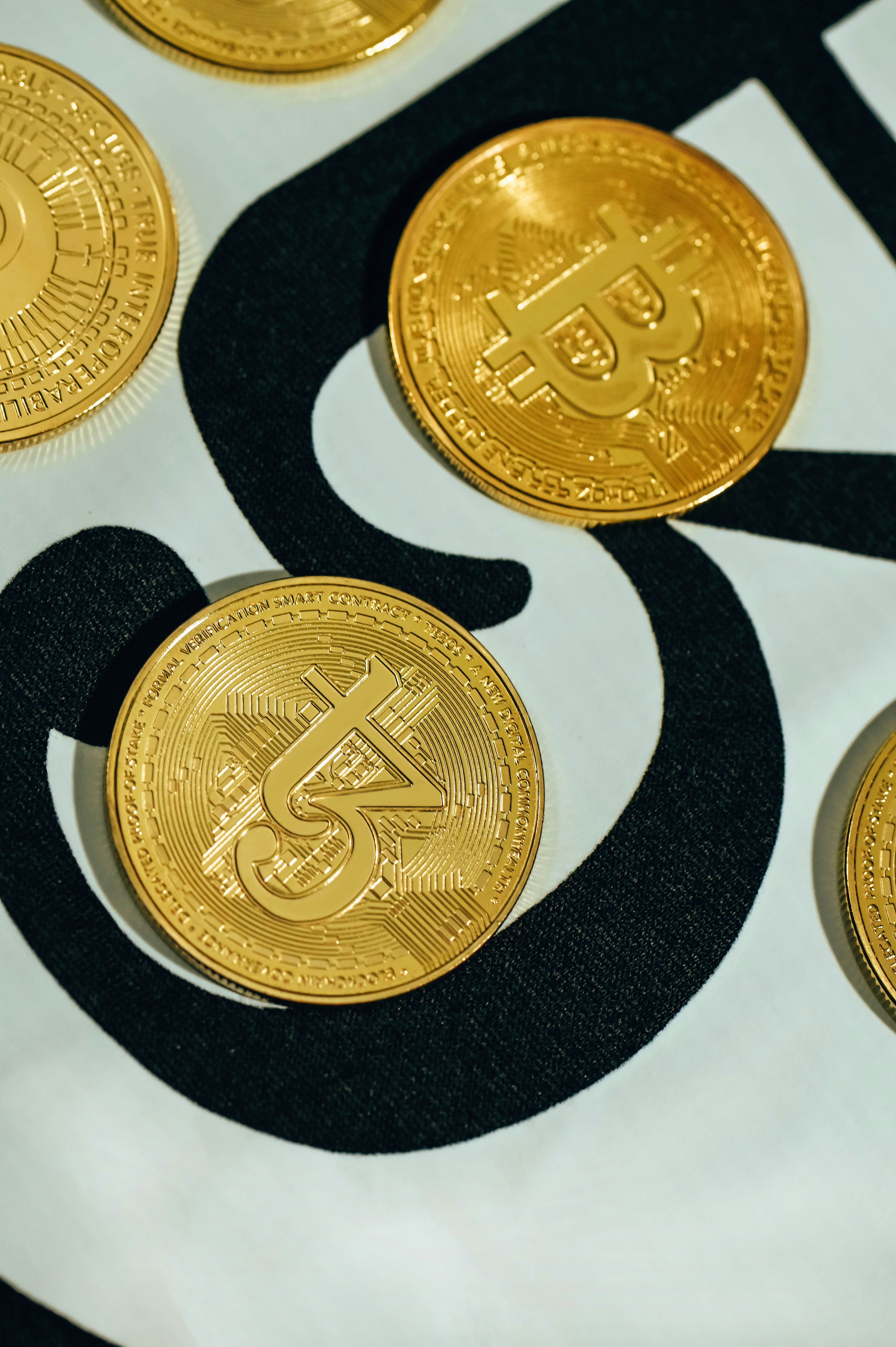 a group of gold bitcoins sitting on top of a table