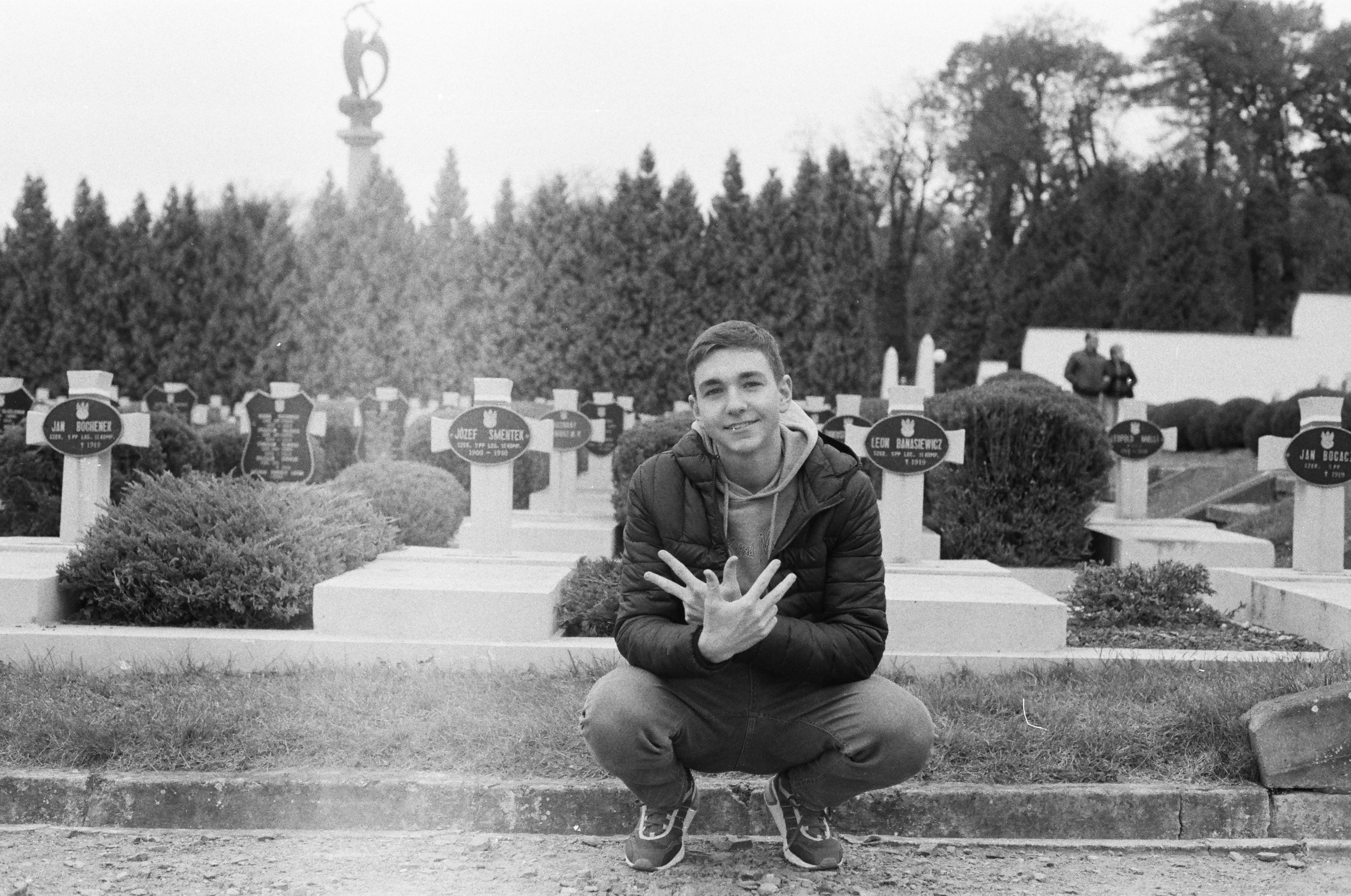 A man kneeling down in front of a cemetery photo – Free Львів Image on ...