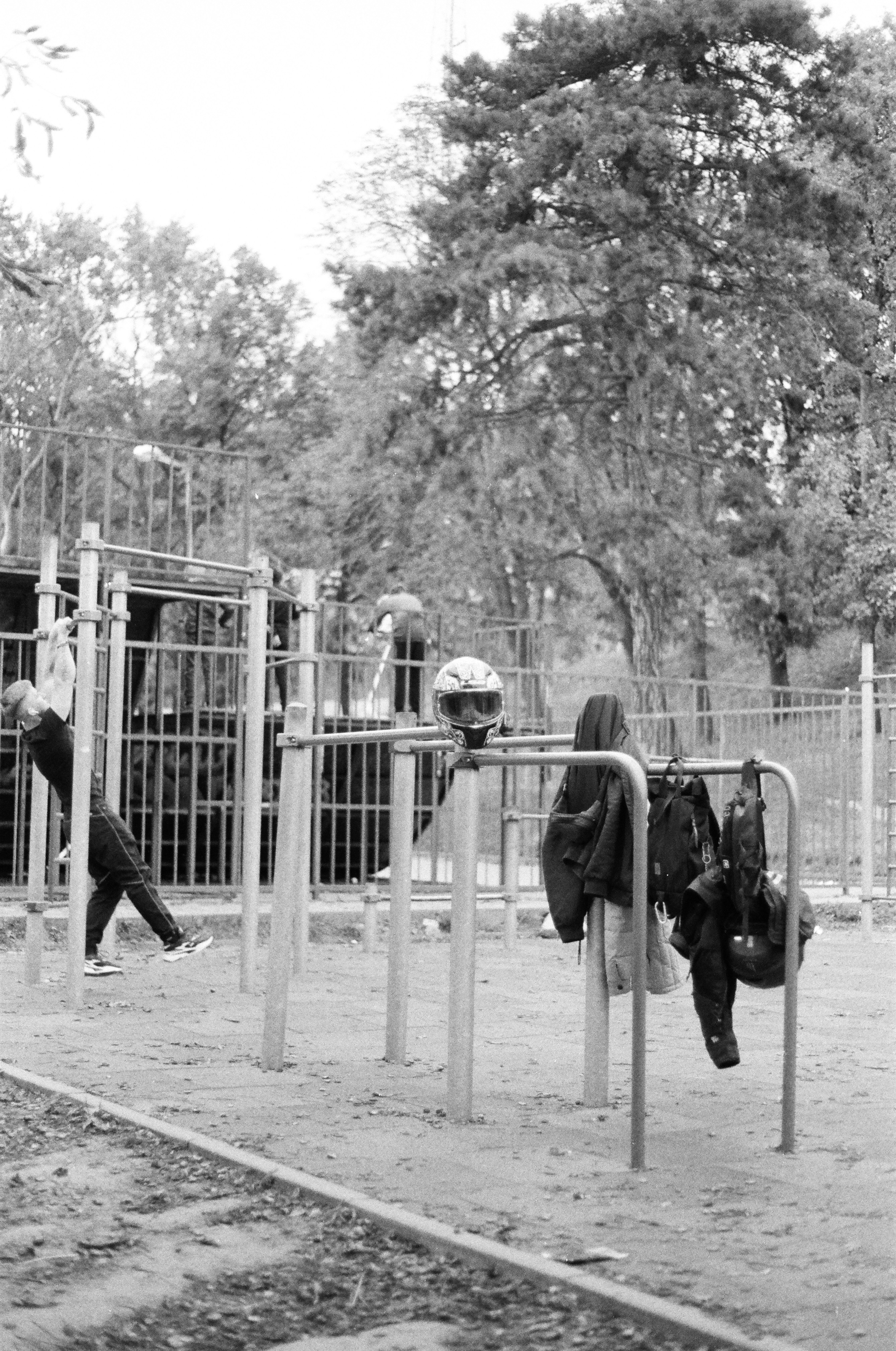 a black and white photo of people on a playground