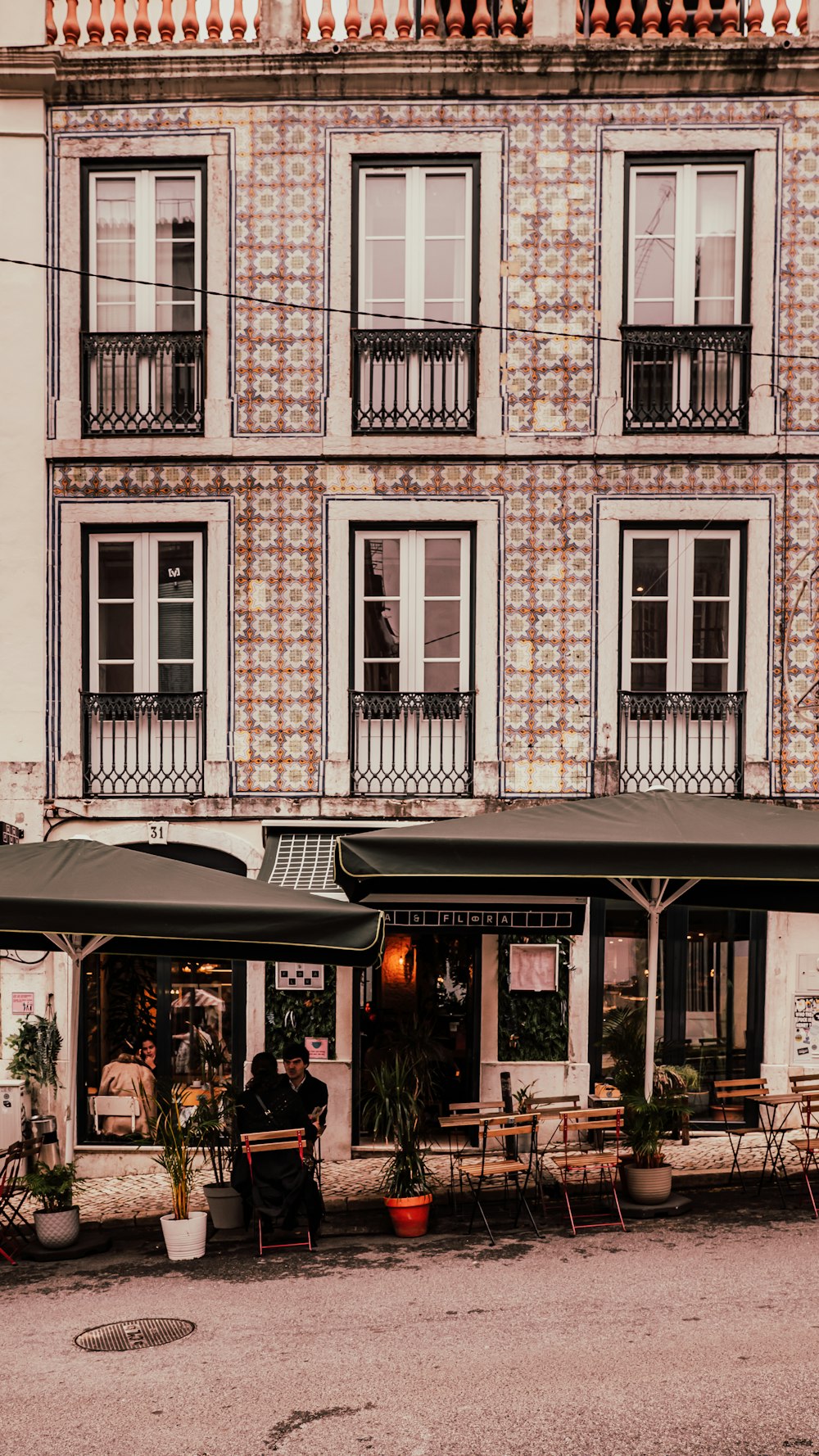 a building with a bunch of tables and chairs outside of it