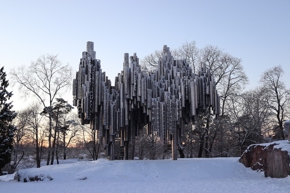 a very tall building made of metal pipes in the snow