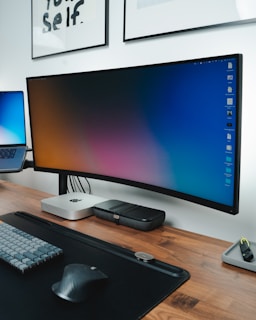 Modern office workspace with computer and cybersecurity elements on a blue background