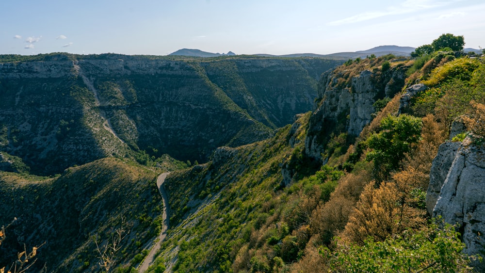 a scenic view of a mountain with a road going through it