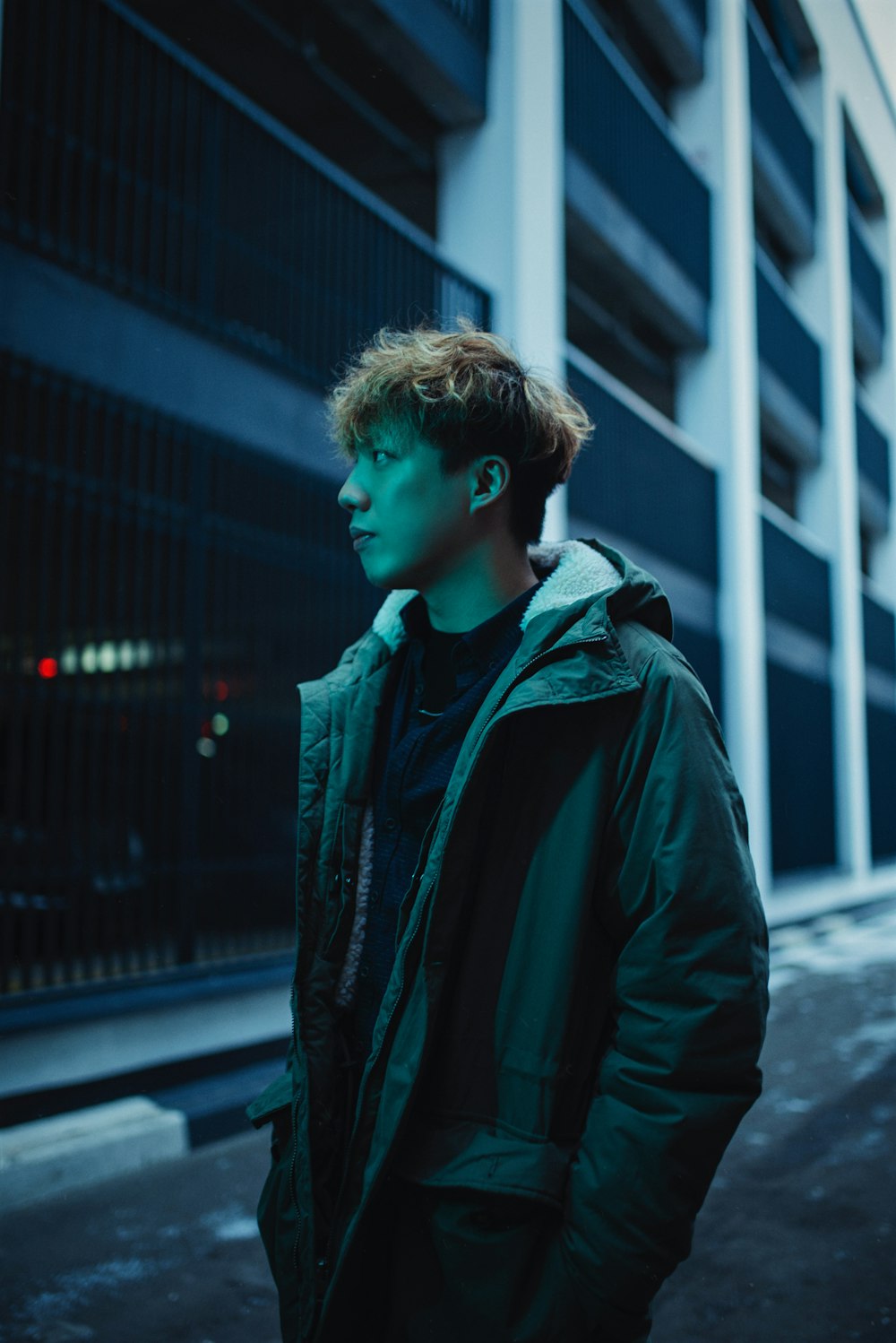 a young man standing in front of a building