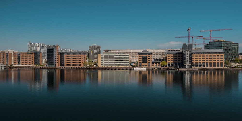 a large body of water with buildings in the background