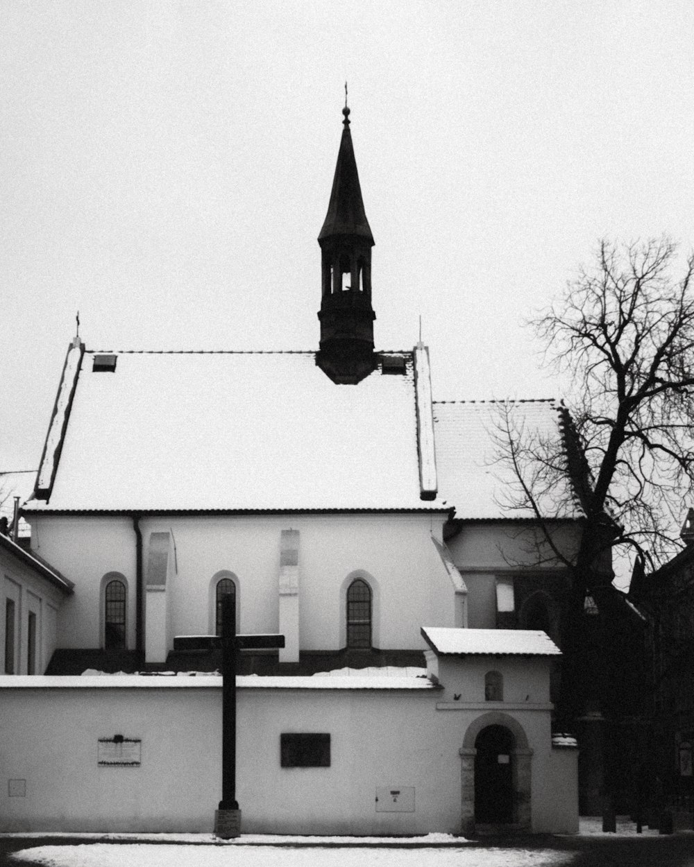 a black and white photo of a church in the snow