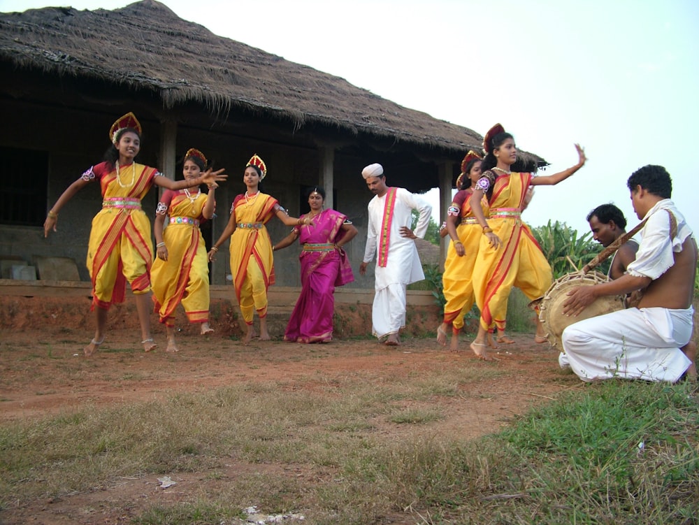 a group of people that are standing in the dirt