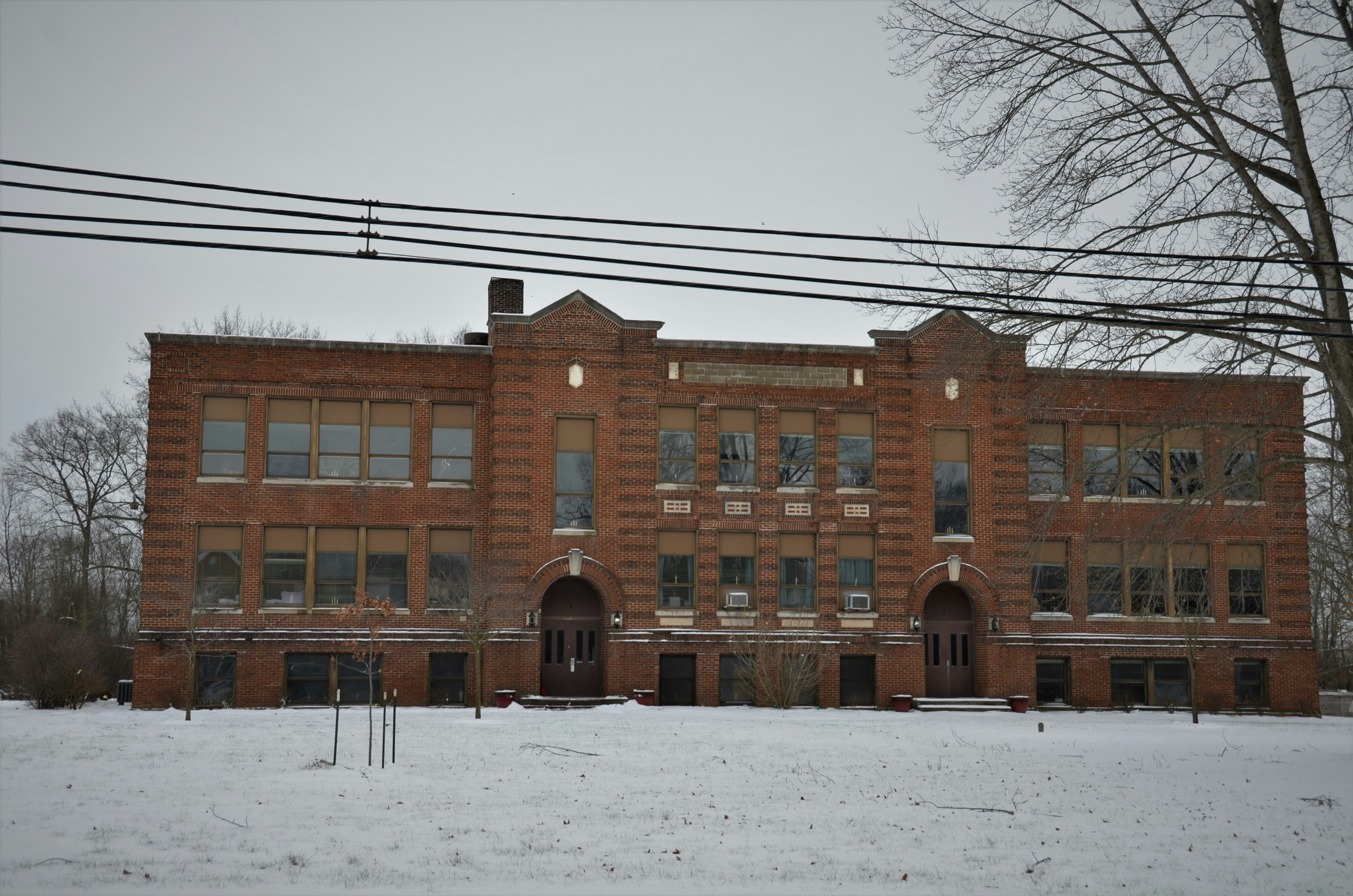 a large brick building with many windows in the snow