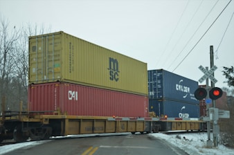 a train with a lot of containers on the back of it
