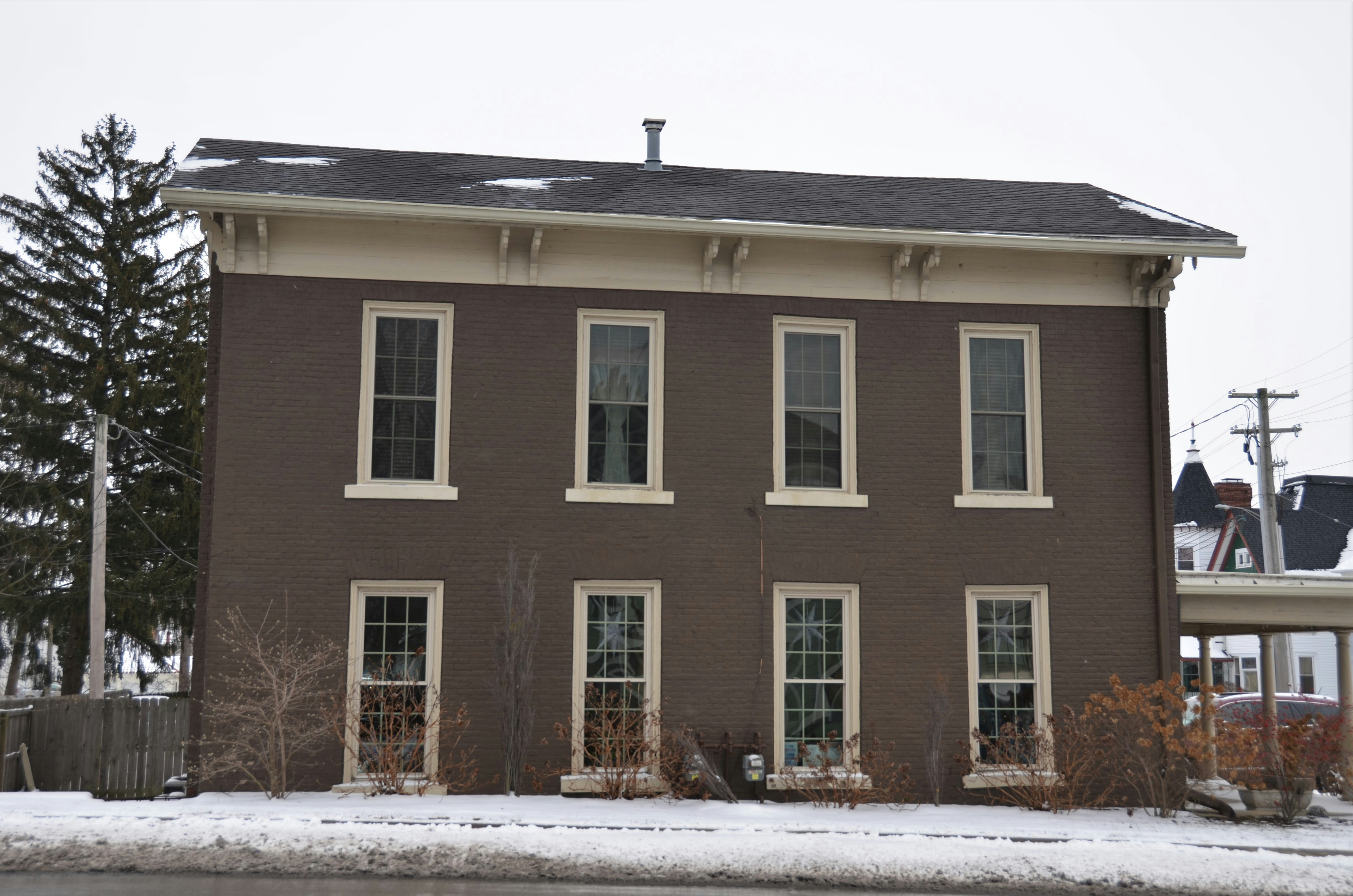 a large brown house with a lot of windows