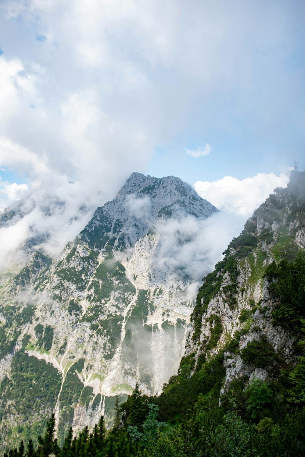 a view of a mountain covered in clouds