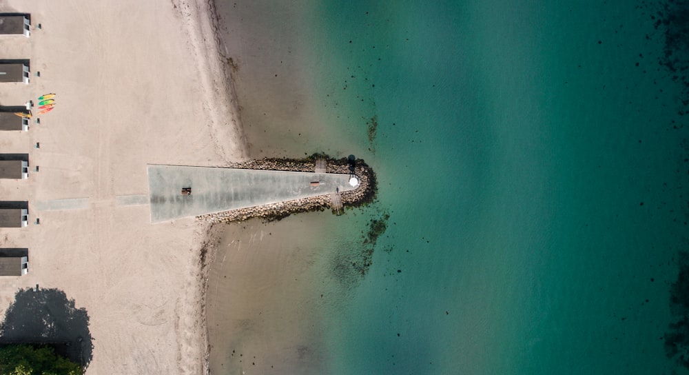an aerial view of a beach with a pier
