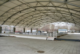 a large open area with a walkway and a fence