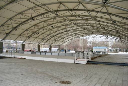 a large open area with a walkway and a fence
