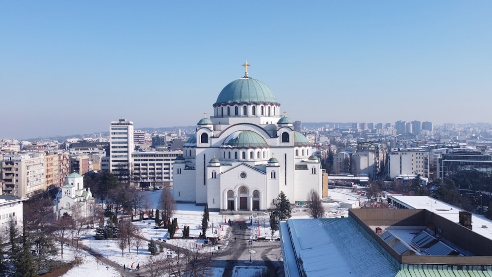 a large white building with a green dome