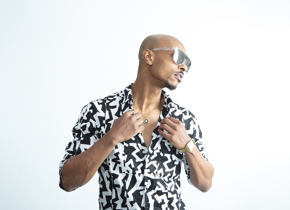 a man wearing a black and white shirt and sunglasses