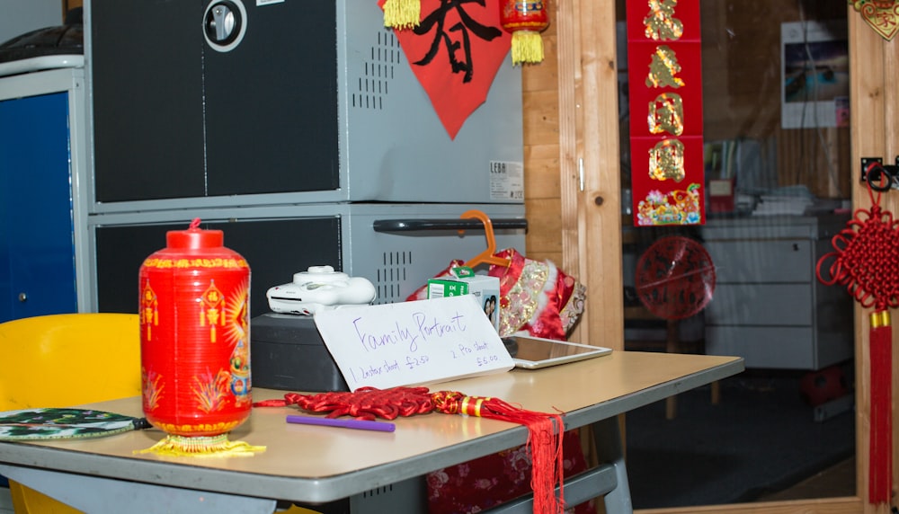 a red bottle sitting on top of a table