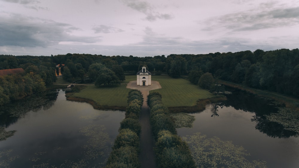 an aerial view of a small church in the middle of a lake