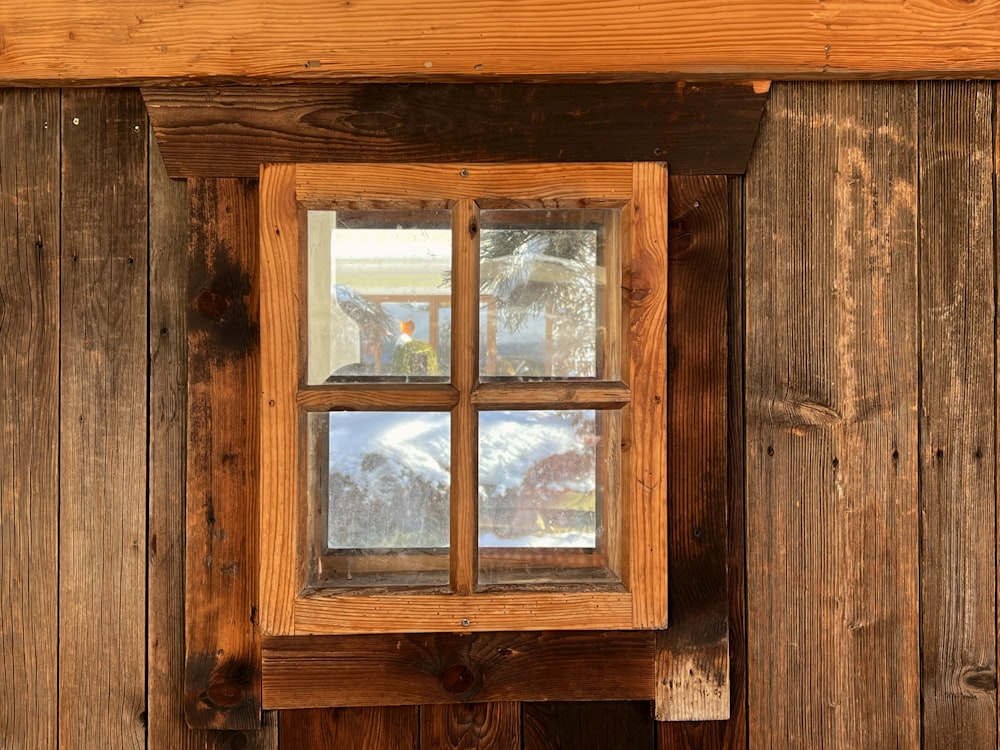 a window in a wooden wall with a window pane