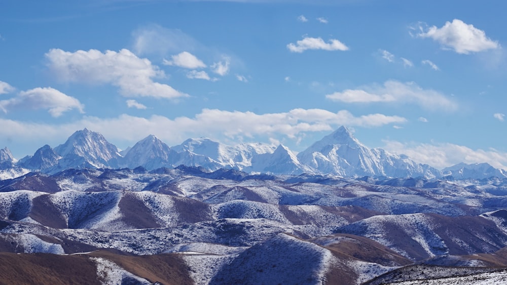 a mountain range with snow covered mountains in the background