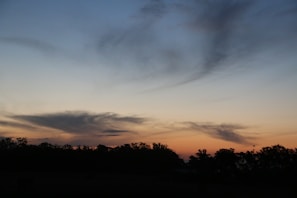 A dreamy horizon at dusk with soft pastel colors blending into a starry night sky.