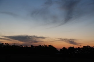 A dreamy horizon at dusk with soft pastel colors blending into a starry night sky.