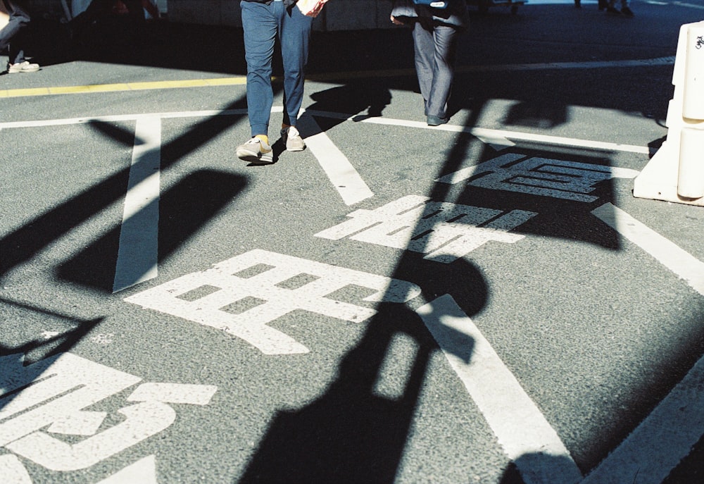 a man walking across a street next to a traffic light