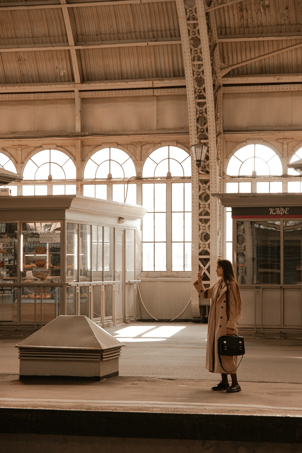 a woman is standing in a train station