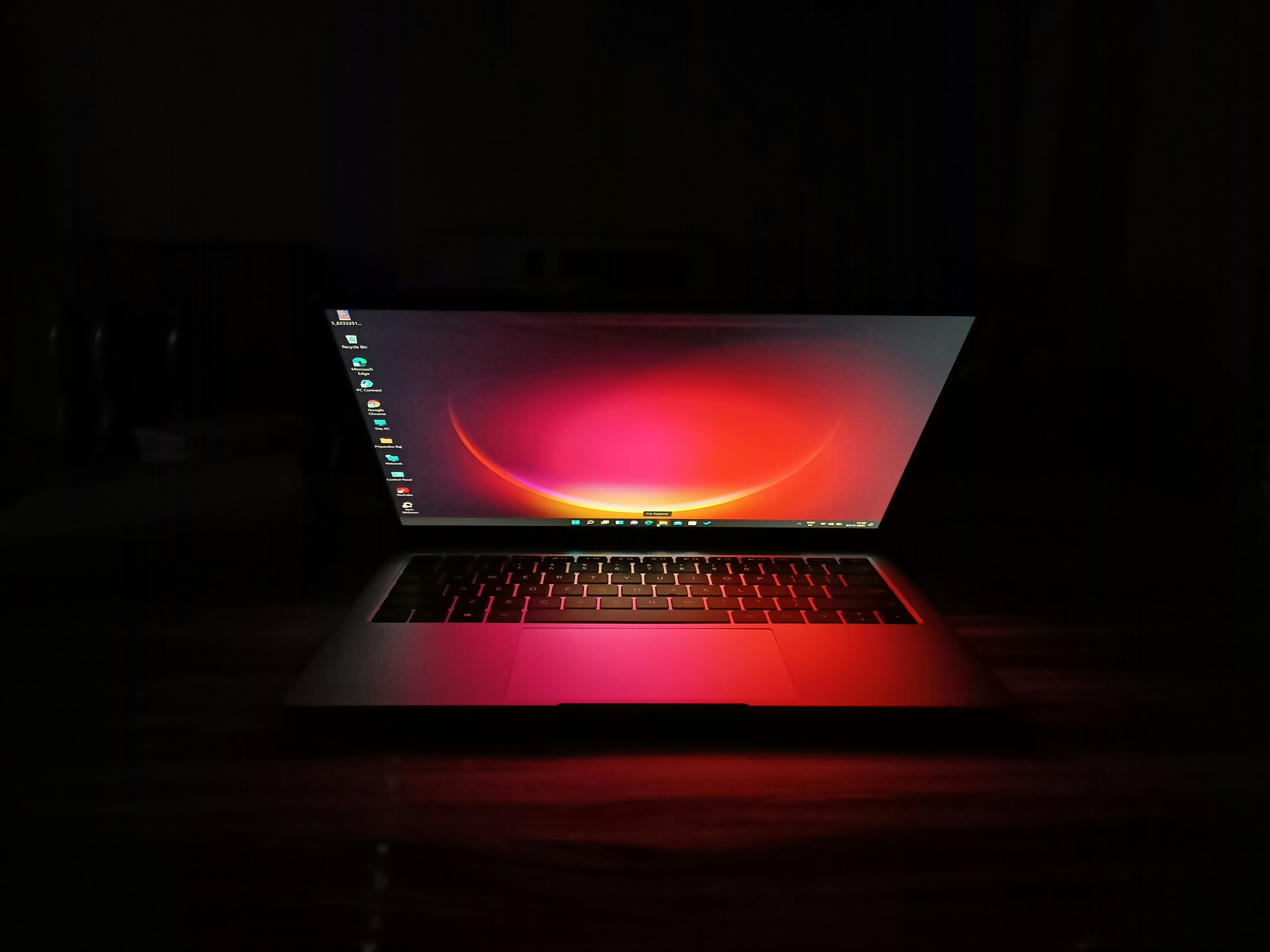 a laptop computer sitting on top of a wooden table
