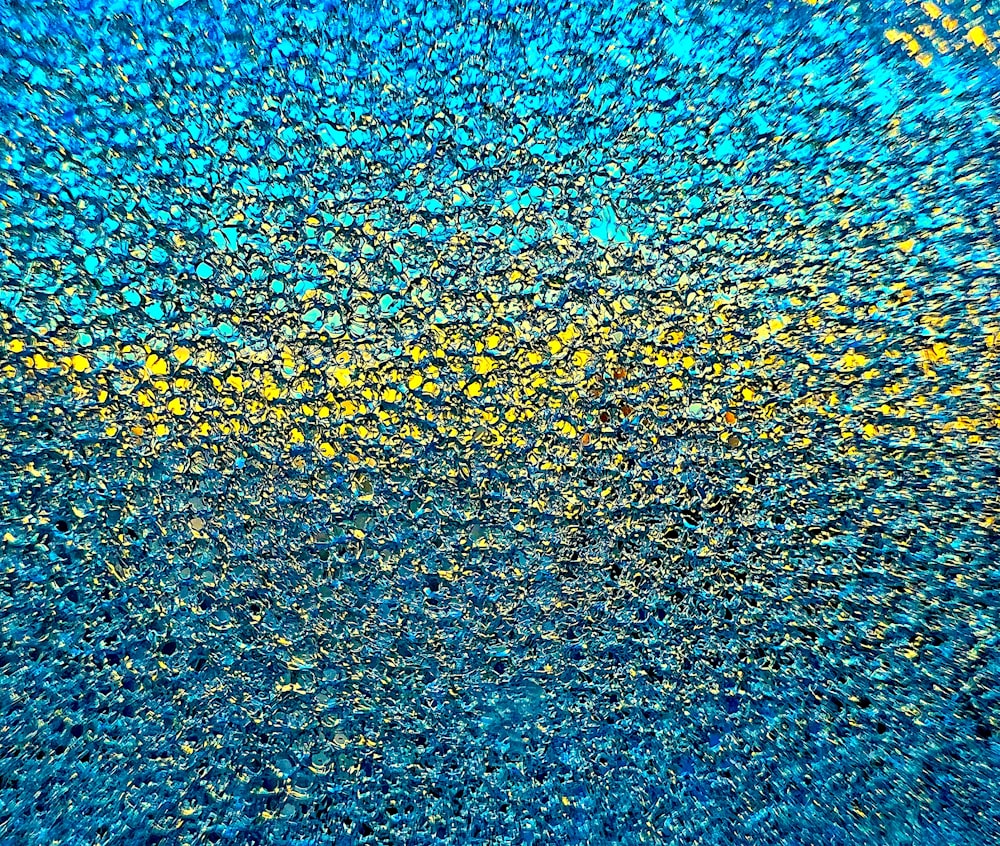 a blue and yellow background with a lot of small dots