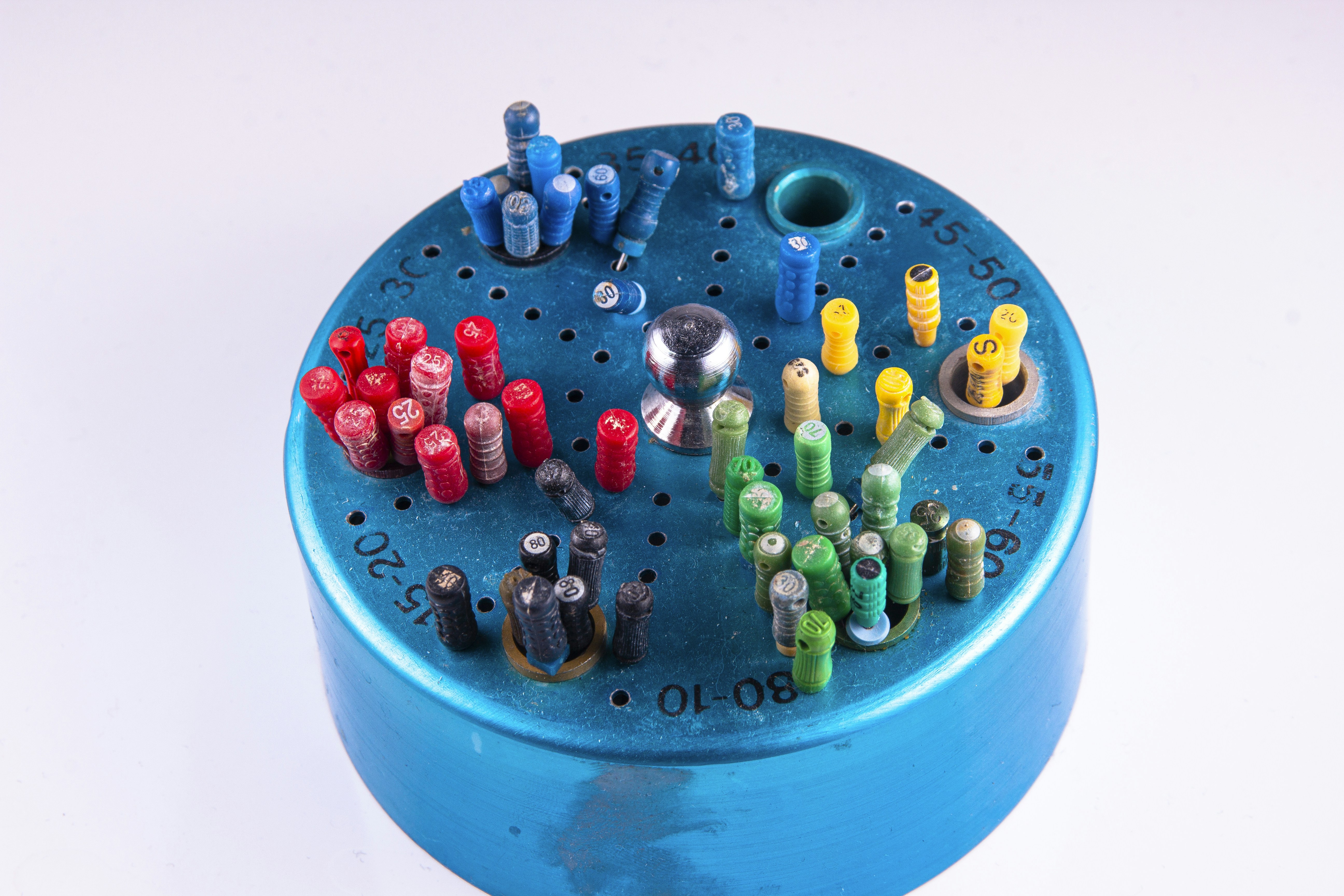 a close up of a blue container with a bunch of small objects in it