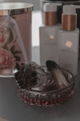A serene scene with sage bundles, crystals, and a softly glowing candle set for an energy cleansing ritual.