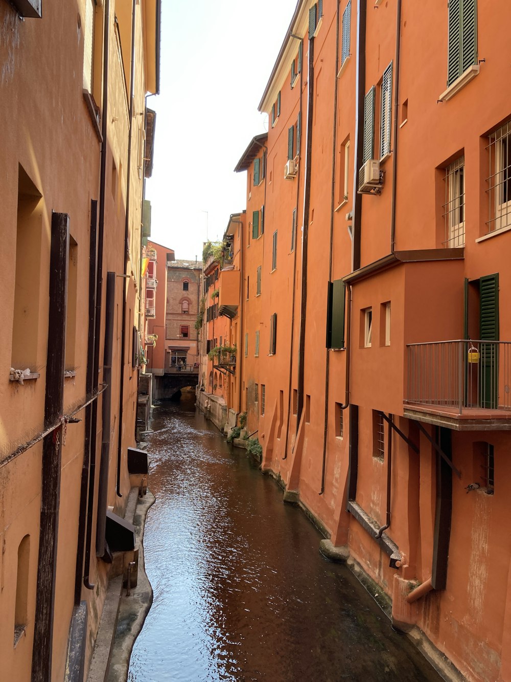 a river running through a city next to tall buildings