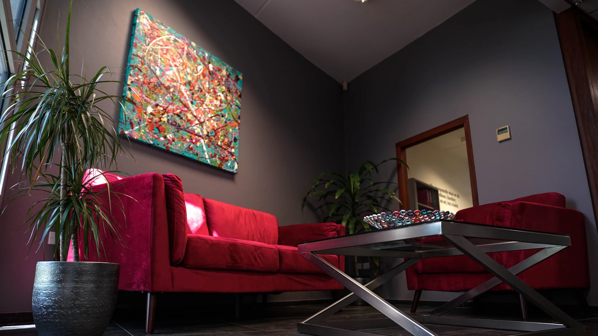 a living room with a red couch and a coffee table