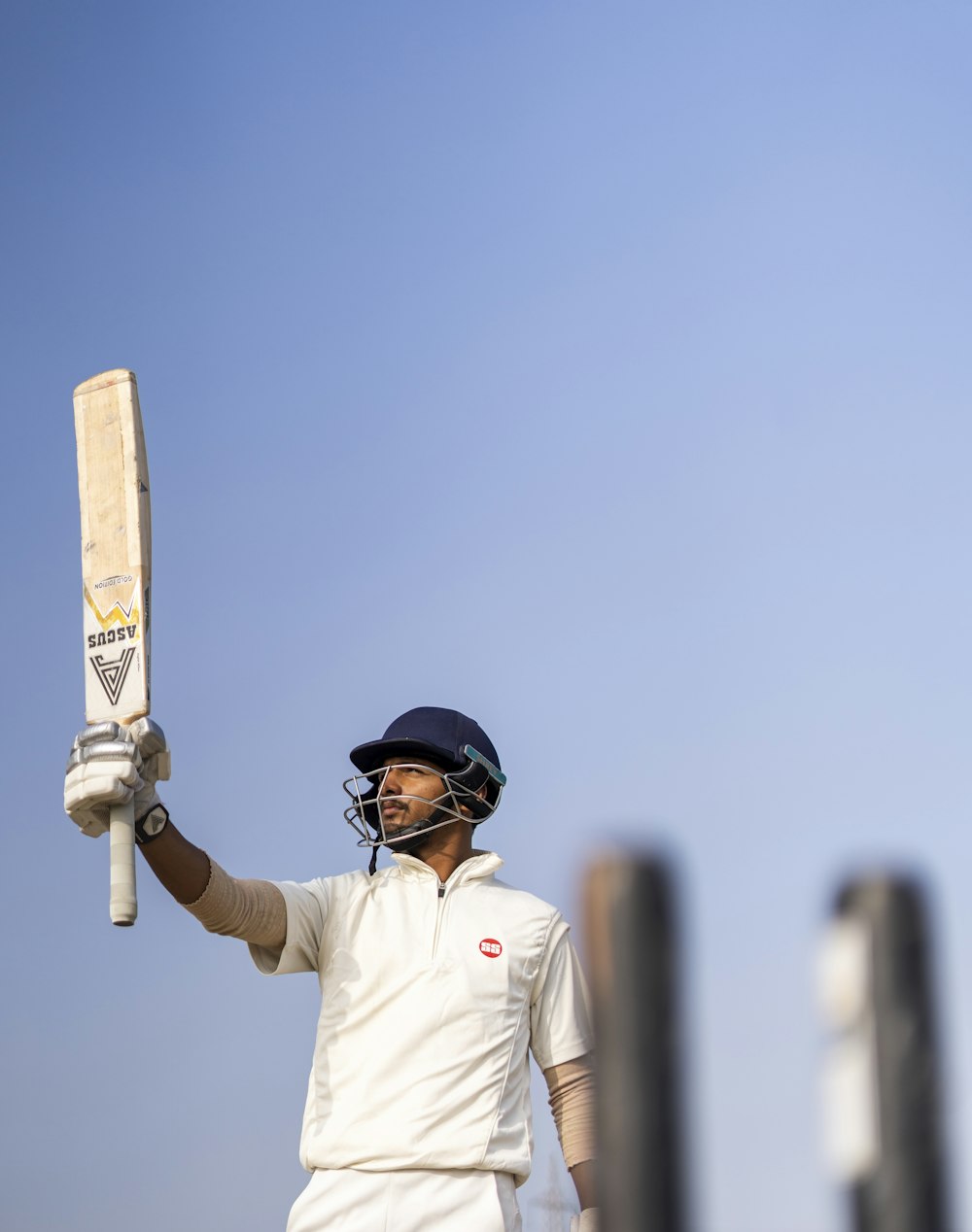 a man holding a cricket bat in his hand
