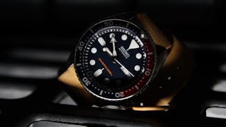 a watch sitting on top of a computer keyboard