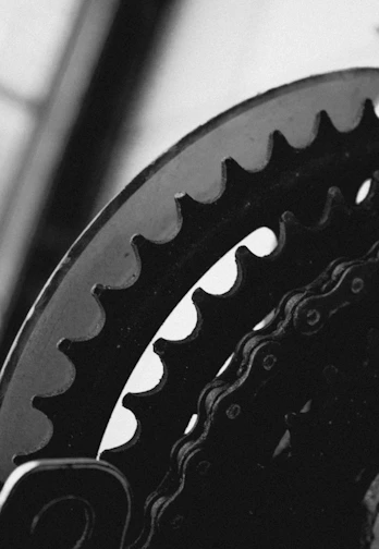 Close-up of shiny bike gears and chain in motion.